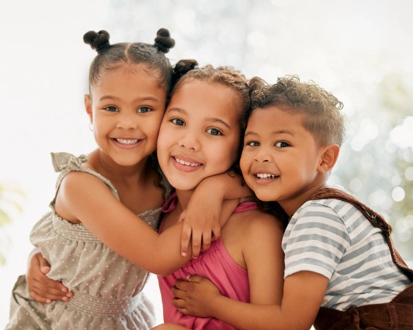 Children smiling together at a dental office