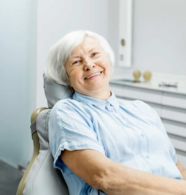 Older woman smiling during dental care