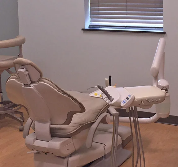 Comfortable dental treatment room with modern dental chair and equipment
